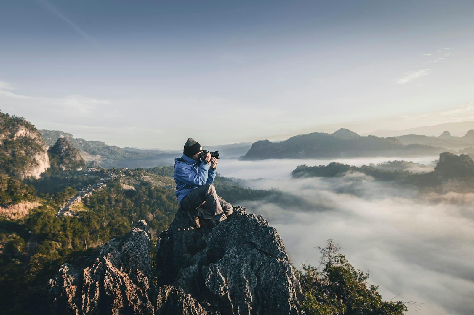A photographer shooting from a ridge above the morning fog