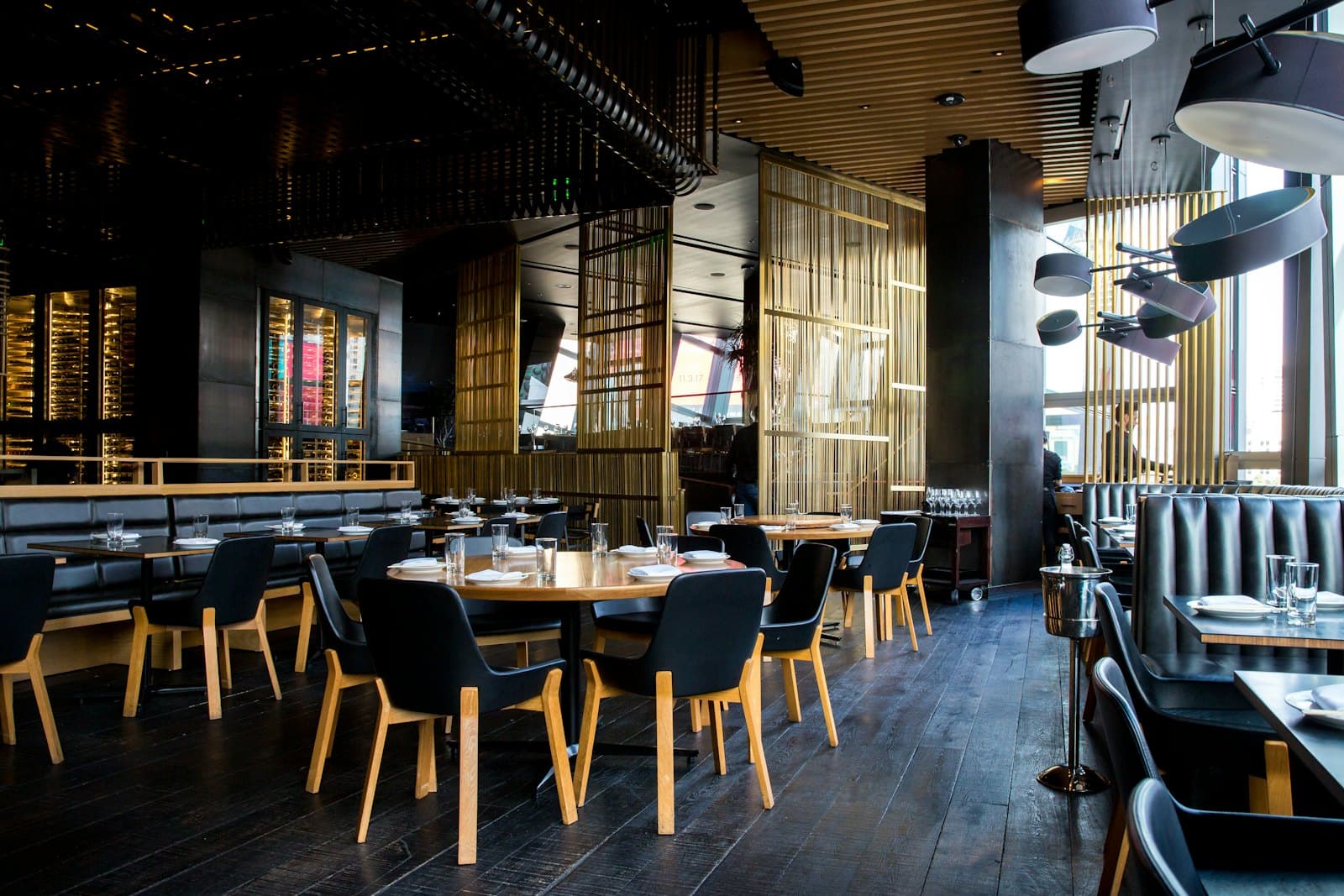 A warmly lit restaurant dining room set for service